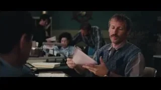 two men in office conversing at desk — The Wolf Of Wall Street