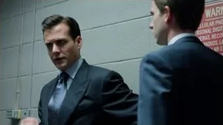 two men in suits by warning sign — Suits