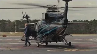Two men walking on airport tarmac — Succession