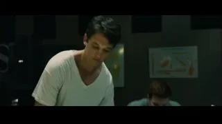 two young men in dimly lit room with whiteboard — Whiplash