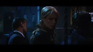 Woman and men in chained dark room — Iron Man