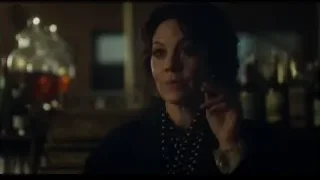 woman holding cigarette in dimly lit room — Peaky Blinders
