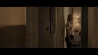 Woman in dimly lit hallway — F1