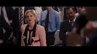 woman in pink blazer, head down, hands clasped — The Wolf Of Wall Street