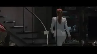 Woman in white suit walking on staircase — Iron Man 3