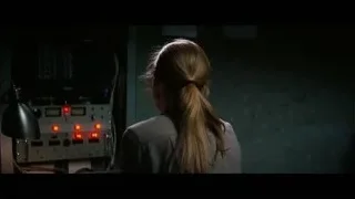 woman looking at control panel in dark room — Interstellar
