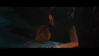 woman looking at unconscious man on bed — Furious Seven