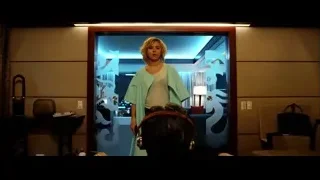 woman looking in mirror in room — Lucy