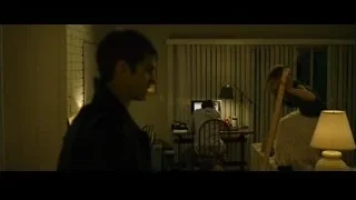 Woman on ladder with man in dimly lit room — The Social Network