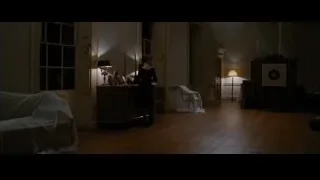 Woman standing in dimly lit room — Batman: The Dark Knight Rises