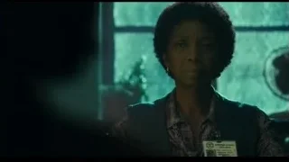 woman standing in front of window — Joker
