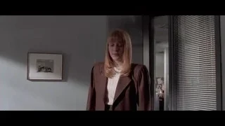woman standing in office hallway looking at camera — American Psycho