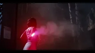 woman with red light saber facing T-Rex — Jurassic World