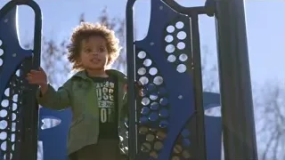 young child standing on blue playground equipment — Screened Out