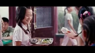 Young girl holding food smiling at camera — The Karate Kid