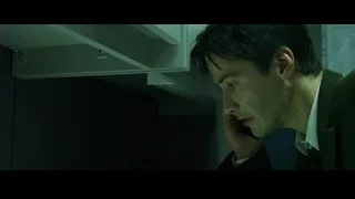 young man in suit holding phone in office — The Matrix