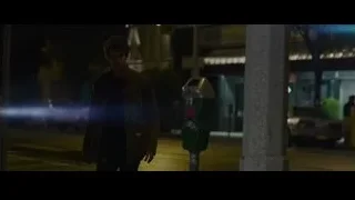 Young man standing by parking meter at night — The Amazing Spider Man