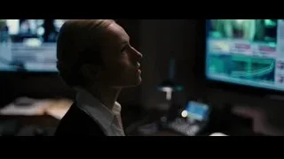 Young woman at multiple monitors in dark room — Batman: The Dark Knight Rises