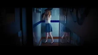 Young woman in dimly lit hallway — La La Land