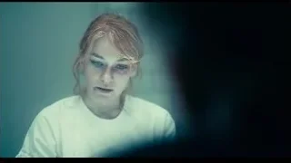 young woman's face in eerie setting — Joker